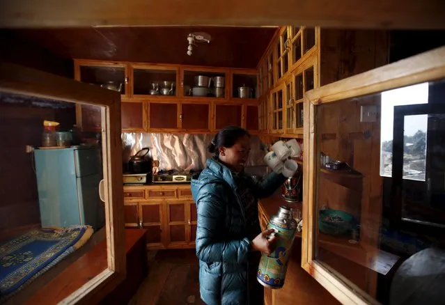 Maya Sherpa works inside the kitchen of her newly-built house after the earthquake earlier this year destroyed her home in Solukhumbu district, also known as the Everest region, in this picture taken November 29, 2015. (Photo by Navesh Chitrakar/Reuters)