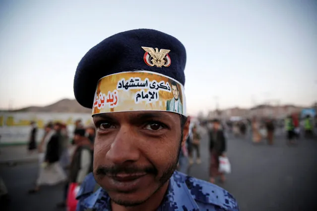 A police trooper wears a headband with a poster of the leader of the Shi'ite Houthi movement Abdul-Malik al-Houthi during a rally commemorating the death of Imam Zaid bin Ali in Sanaa, Yemen October 26, 2016. The headband reads “The anniversary of the martyrdom of Imam Zaid bin Ali”. (Photo by Khaled Abdullah/Reuters)