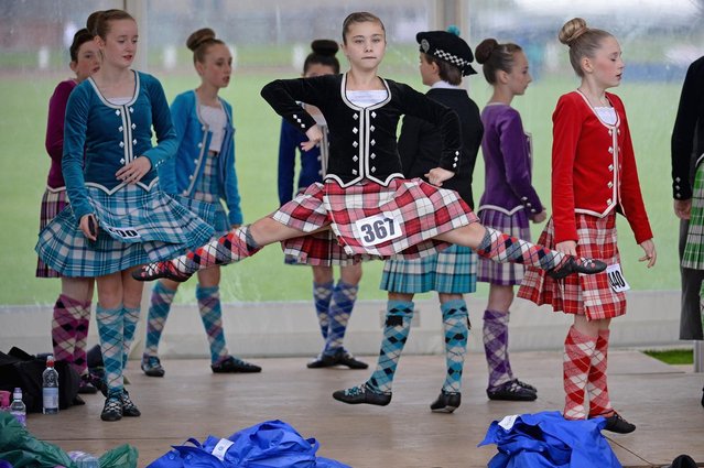 Dancers warm up before competing at the Cowal Highland Gathering on August 30, 2013 in Dunoon, Scotland. First held in 1894, the Cowal Games are held over three and are one of the largest in the world attracting competitors from Canada, USA, South Africa, Australia and New Zealand. (Photo by Jeff J Mitchell/Getty Images)