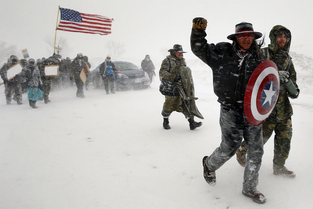 Veterans join activists in a march to Backwater Bridge just outside the Oceti Sakowin camp during a snow fall as “water protectors” continue to demonstrate against plans to pass the Dakota Access pipeline adjacent to the Standing Rock Indian Reservation, near Cannon Ball, North Dakota, U.S., December 5, 2016. (Photo by Lucas Jackson/Reuters)