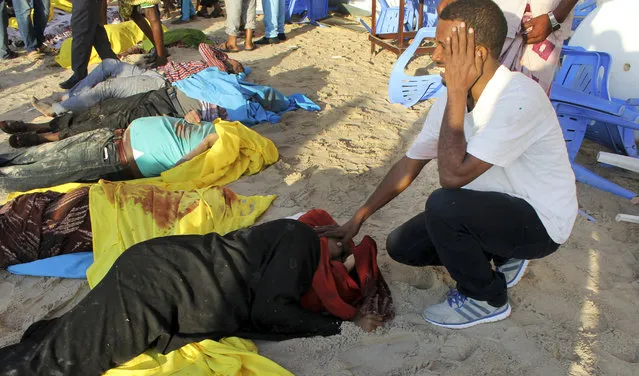 In this Friday, January 22, 2016 file photo, a Somali man cries after identifying the dead body of his sister on the beach following an overnight attack on a beachfront restaurant in Mogadishu, Somalia. The number of deadly attacks by Islamic extremists is mounting across Africa, raising questions about the resurgence of armed groups once seen to be in decline. (Photo by Farah Abdi Warsameh/AP Photo)