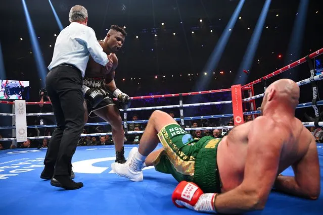 Francis Ngannou knocks down Tyson Fury during the Heavyweight fight between Tyson Fury and Francis Ngannou at Boulevard Hall on October 28, 2023 in Riyadh, Saudi Arabia. (Photo by Justin Setterfield/Getty Images)