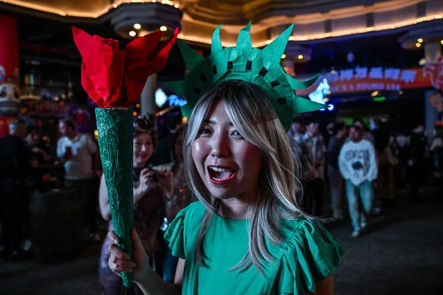 A costumed reveller walks in Found 158, an area of bars, clubs and reataurants, ahead of Halloween in the district of Huangpu, in Shanghai, on October 27, 2023. (Photo by Hector Retamal/AFP Photo)