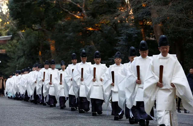 Shinto priests walk in a line to attend a ritual to usher in the upcoming New Year at the Meiji Shrine in Tokyo, Japan, December 31, 2016. (Photo by Kim Kyung-Hoon/Reuters)