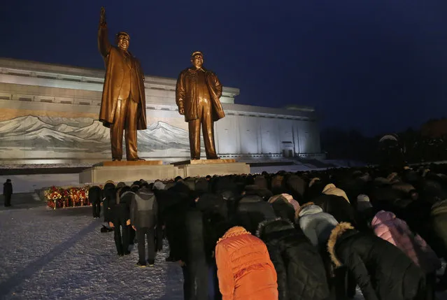 North Koreans bow at the bronze statues of their late leaders Kim Il Sung and Kim Jong Il at Mansu Hill Grand Monument in Pyongyang, North Korea, Sunday, December 16, 2018.  Many North Koreans are marking the seventh anniversary of the death of leader Kim Jong Il with visits to the statues and vows of loyalty to his son, Kim Jong Un. (Photo by Dita Alangkara/AP Photo)