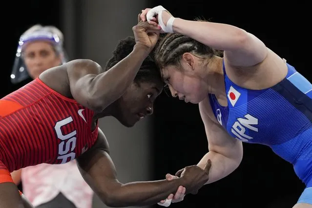 In this August 2, 2021, file photo, United States' Tamyra Marianna Stock Mensah, left, and Japan's Sara Dosho compete during the women's 68kg freestyle wrestling match at the 2020 Summer Olympics in Chiba, Japan. Tokyo Olympians are exercising extraordinary discipline against the coronavirus. They are sealed off in a sanitary bubble that has made competition possible but is also squeezing a lot of fun from their Olympic experience. (Photo by Aaron Favila/AP Photo/File)
