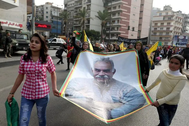 Kurdish people hold flags and pictures of jailed Kurdish leader Abdullah Ocalan of the Kurdistan Workers Party (PKK) during a demonstration calling for his release in Beirut, Lebanon February 14, 2016. (Photo by Hasan Shaaban/Reuters)