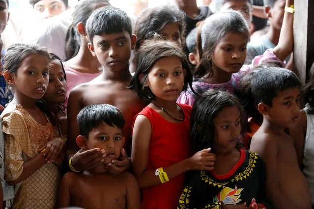 Rohingya refugees children queue for snacks at their temporary shelter provided by the Aceh government, in Lhok Seumawe, Aceh, Indonesia, 28 November 2023. The UNHCR observed that 804 Rohingya refugees were housed at the former Lhok Seumawe immigration office as a temporary shelter for Rohingya refugees who came to Aceh in recent weeks. Aceh is one of the transit areas for Rohingya refugees before they continue their journey to other countries such as Malaysia and Australia. (Photo by Hotli Simanjuntak/EPA/EFE)