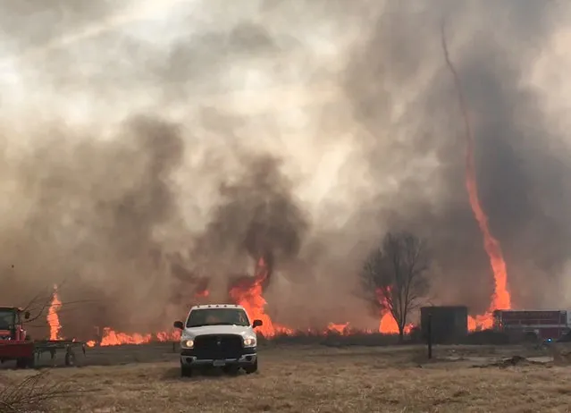 In this image made from a February 18, 2016 video by Dean Cull, deputy chief of the Southern Platte Fire Protection District, a twisting fire, also known as a fire tornado, shoots up in the air as the grass fires spread on the field in Platte County, Mo. Firefighters in northwest Missouri are continuing to watch the site of a grass fire fueled by high winds that damaged up to 1,500 acres of land in Platte County. (Photo by Dean Cull/Southern Platte Fire Protection District via AP Photo)