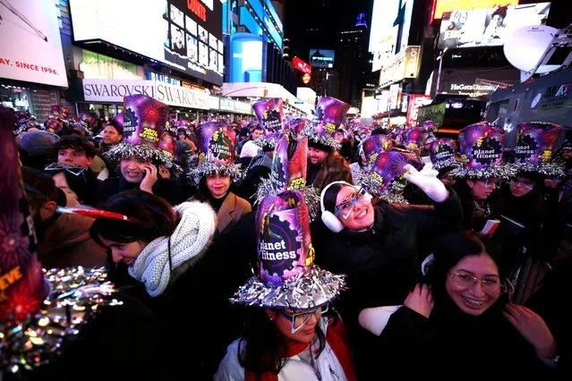 Revelers pose as they celebrate New Year's Eve in Times Square on December 31, 2023, in New York City. (Photo by John Lamparski/AFP Photo)