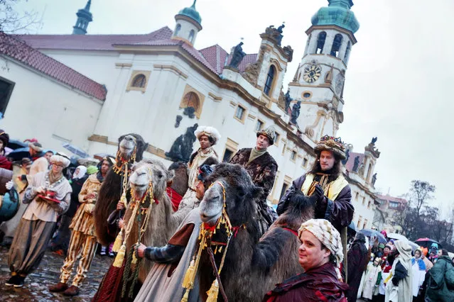 Men dressed as the Three Kings, Jasper, Melchior and Balthazar, ride on camels during the traditional Three Kings Procession on January 5, 2014 in Prague, Czech Republic. The procession is a re-enactment of the journey made by the Three Wise Men to visit the infant Jesus, which marks the end of the Christmas festivities in Prague. (Photo by Frantisek Vlcek/Getty Images/Isifa)