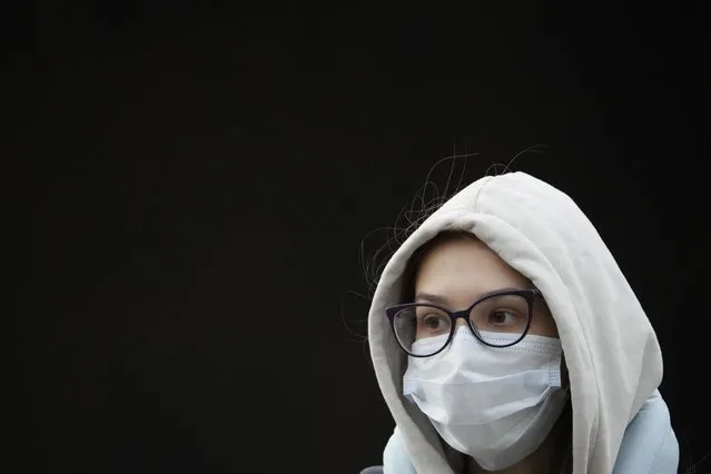 A young woman wearing a face mask to help curb the spread of the coronavirus leaves a subway in Moscow, Russia, Friday, October 15, 2021. Russia's daily tolls of coronavirus infections and deaths have surged to another record in a quickly mounting figure that has put a severe strain on the country's health care system. The record for daily COVID-19 deaths in Russia has been broken repeatedly over the past few weeks as fatalities steadily approach 1,000 in a single day. (Photo by Alexander Zemlianichenko/AP Photo)