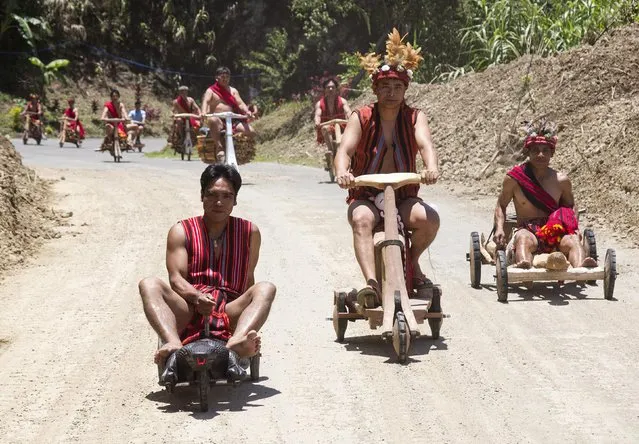 Filipino tribesmen participate in  a wooden scooter race spanning 4.3 km (2.7 miles) in Banaue, Ifugao, north of Manila April 28, 2015. The race is part of the annual Imbayah festival. The festival showcases the rich culture and the ingenuity of the villagers whose ancestors carved the famous Ifugao rice terraces more than 2,000 years ago. (Photo by Harley Palangchao/Reuters)