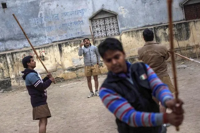 In this Tuesday, December 11, 2018 photo, members of the Rashtriya Swayamsevak Sangh (RSS) gather during an early morning shakha, a daily training, in Prayagraj, India. (Photo by Bernat Armangue/AP Photo)