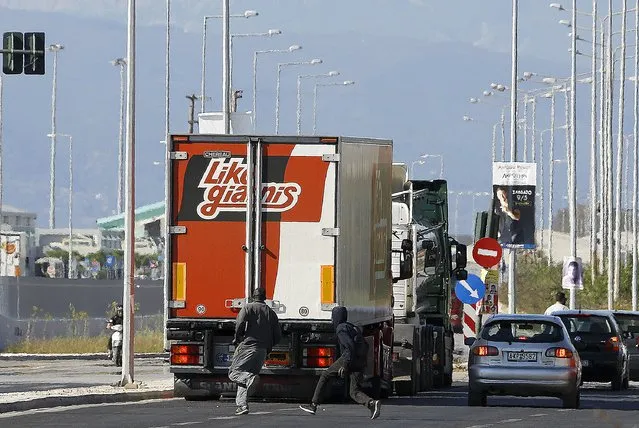 Sudanese immigrants run behind a truck, which they hope to climb onto, in order to board a ferry to flee to Italy, in the western Greek town of Patras May 4, 2015. (Photo by Yannis Behrakis/Reuters)