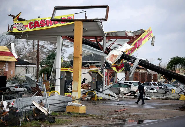 A police officer walks through a damaged gas station along Chef Menture Avenue after a tornado touched down in the eastern part of the city on February 7, 2017 in New Orleans, Louisiana. (Photo by Sean Gardner/Getty Images)
