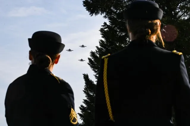 A joint service flyover honoring the centennial anniversary of the Tomb of the Unknown Soldier takes place at Arlington National Cemetery on Veterans Day, in Arlington, Virginia, on November 11, 2021. (Photo by Kenny Holston/Pool via AFP Photo)