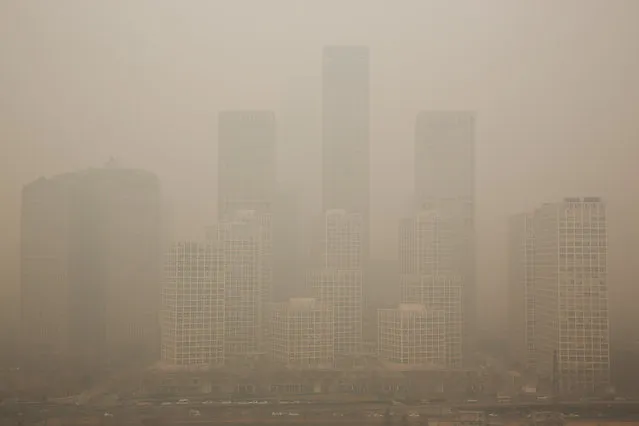 A general view of the pollution covered Beijing CBD on February 25, 2014 in Beijing, China. The air pollution has caused an increase in the number of people seeking hospital treatment for respiratory problems and the public are asked to avoid outdoor activities. (Photo by Lintao Zhang/Getty Images)
