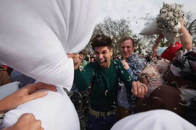 Revellers take part in a mass pillow fight in Kennington Park in south London on International Pillow Fight Day, April 2, 2016. (Photo by Niklas Halle'n/AFP Photo)