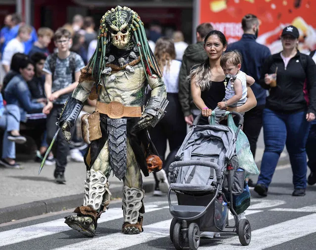A cosplayer dressed as Predator walks at a cosplayer meeting in Bottrop, Germany, Saturday, June 15, 2019. (Photo by Martin Meissner/AP Photo)