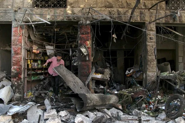 A man inspects damaged shops after an airstrike on a market in the town of Maarat al-Numan in the insurgent stronghold of Idlib province, Syria April 19, 2016. (Photo by Ammar Abdullah/Reuters)