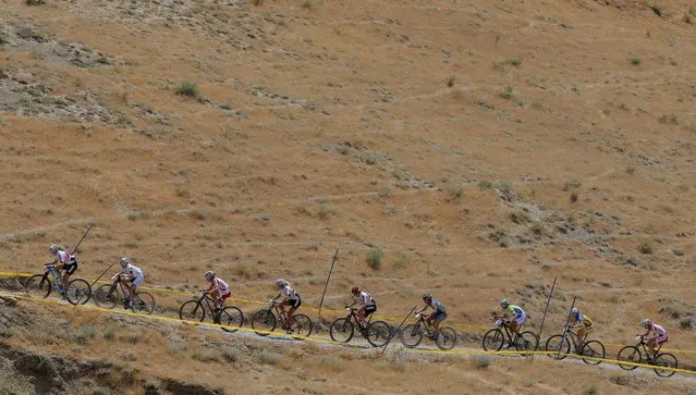 Athletes compete during the mountain bike competition at the 2015 European Games in Baku, Azerbaijan, Saturday, June 13, 2015. (AP Photo/Dmitry Lovetsky)