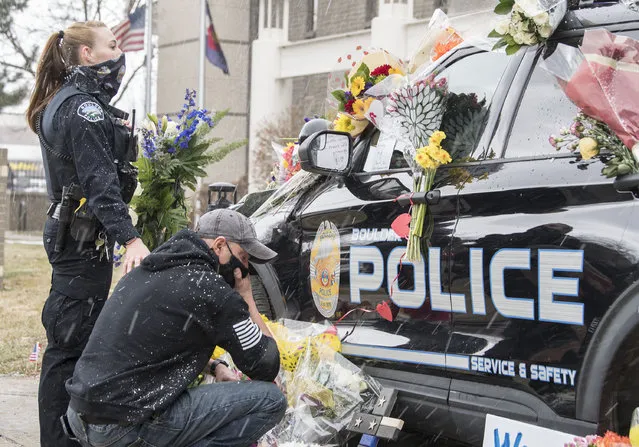 A police vehicle driven by slain officer Eric Talley, who was among 10 people killed by a gunman at the King Soopers grocery store, is parked outside the police station where people placed flowers and messages in Colorado, USA on March 23, 2021. (Photo by PJ Heller/ZUMA Wire/Rex Features/Shutterstock)