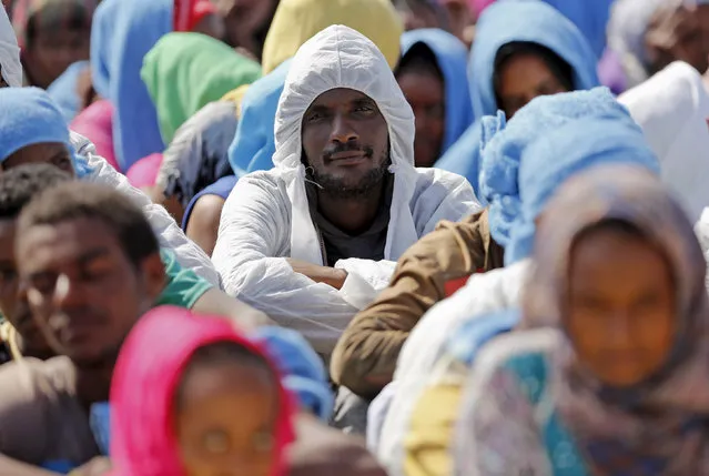 Migrants rest after disembarking from the expedition vessel Phoenix in the Sicilian harbour of Augusta, Italy June 17, 2015. REUTERS/Antonio Parrinello