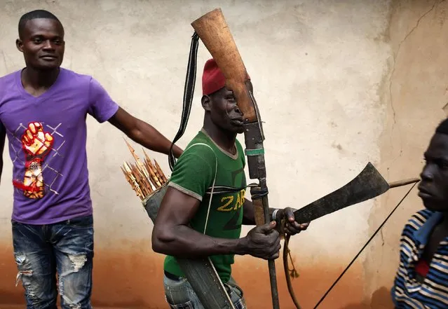 A member of the anti-balaka, a Christian militia, walks with his weapons in the village of Zawa April 8, 2014. (Photo by Goran Tomasevic/Reuters)