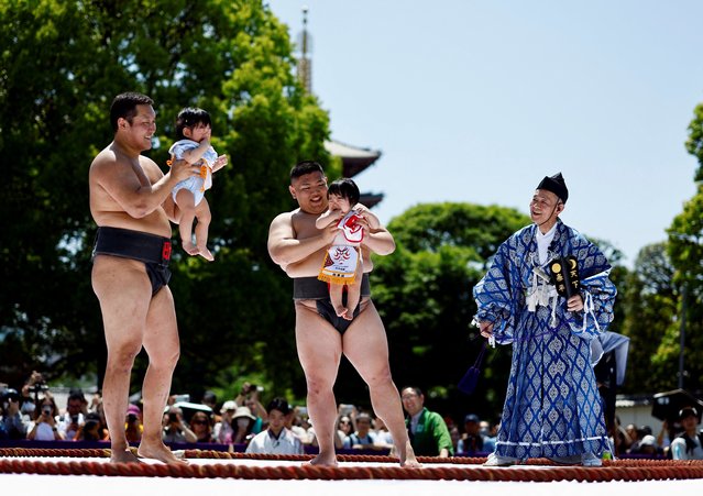 Babies cry while held up by amateur sumo wrestlers during “Nakizumo” or a baby-crying sumo contest at Sensoji temple in Tokyo, Japan, on April 28, 2024. (Photo by Issei Kato/Reuters)