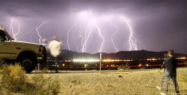 Southern California storm chasing photographers take pictures of the mass lightning bolts lighting up night skies from monsoon storms passing over the high deserts, early Wednesday north of Barstow, California, July 1, 2015. Picture taken using long exposure. (Photo by Gene Blevins/Reuters)