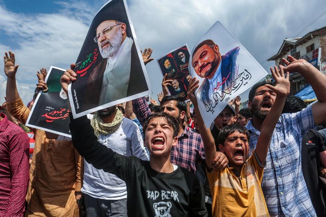 Shiite Muslims shout slogans as they express their grief for Iran's late president Ebrahim Raisi who died in a helicopter crash, during a solidarity march on the outskirts of Srinagar on May 24, 2024. (Photo by Abid Bhat/AFP Photo)