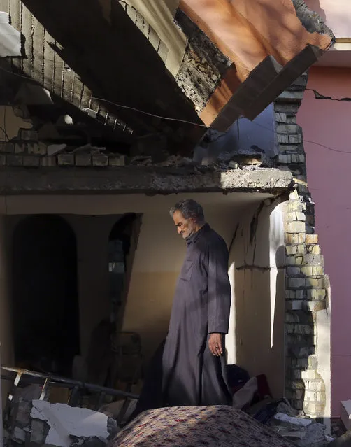Hussein Jassim walks through the ruins of his house in the Iraqi city of Ramadi on April 3, 2016, months after the city was retaken from Islamic State group control. More than 3,000 buildings were destroyed and damaged in fighting or by scorched earth tactics by the militants. For many residents, their homes represented their entire life's savings, and few have the means to rebuild, presenting a massive reconstruction task for an overburdened Iraqi government. (Photo by Khalid Mohammed/AP Photo)