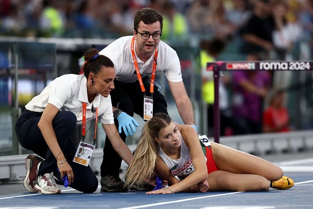 Hungary's athlete Anna Toth receives help after a fall in the women's 100m hurdles semifinal during the European Athletics Championships at the Olympic stadium in Rome on June 8, 2024. (Photo by Anne-Christine Poujoulat/AFP Photo)