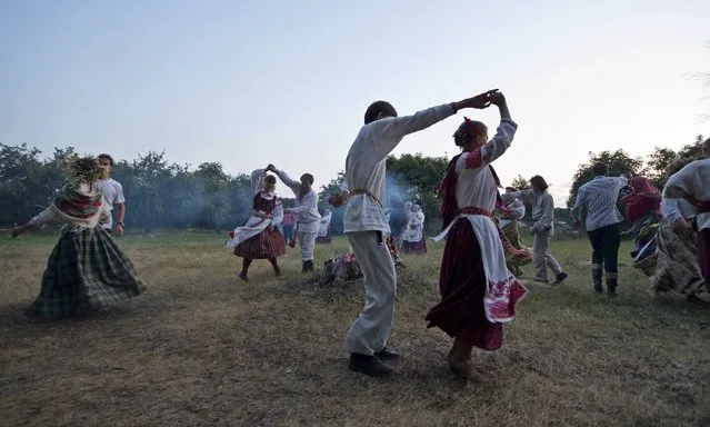 People dance as they take part in the festival of national traditions “Piatrovski” in the village of Shipilovichi, south of Minsk, July 12, 2015. (Photo by Vasily Fedosenko/Reuters)