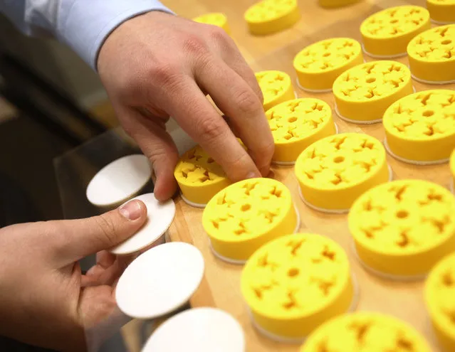 Intern Jim D'Andrea detaches plastic planetary gears after they were 3D printed at America Makes, the National Additive Manufacturing Innovation Institute in Youngstown, Ohio, March 5, 2014. (Photo by Jason Cohn/Reuters)