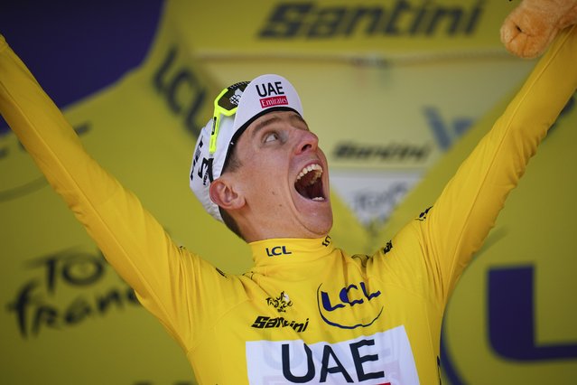 Slovenia's Tadej Pogacar, wearing the overall leader's yellow jersey, celebrates on the podium after the seventeenth stage of the Tour de France cycling race over 177.8 kilometers (110.5 miles) with start in Saint-Paul-Trois-Chateaux and finish in Superdevoluy, France, Wednesday, July 17, 2024. (Photo by Daniel Cole/AP Photo)