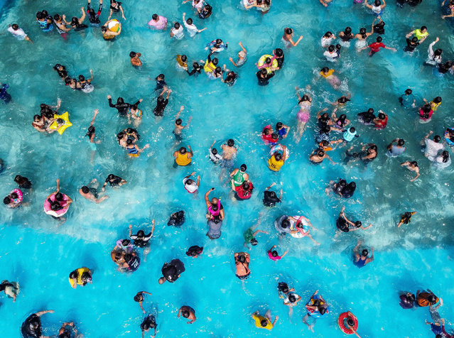 An aerial drone photo taken on May 5, 2024 shows people cooling off in a swimming pool at a resort in Bulacan Province, the Philippines. People spend time at pools to cool off amid heatwave in the Philippines. (Photo by Xinhua News Agency/Rex Features/Shutterstock)