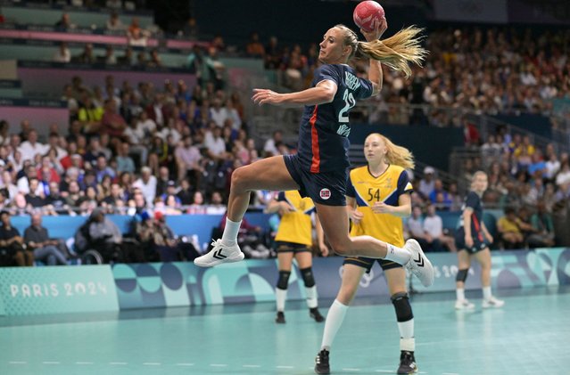 Norway's left wing #23 Camilla Herrem attempts to shoot the ball during the women's preliminary round group A handball match between Norway and Sweden of the Paris 2024 Olympic Games, at the Paris South Arena in Paris, on July 25, 2024. (Photo by Damien Meyer/AFP Photo)