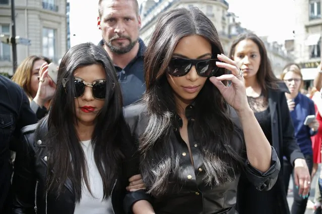 TV personality Kim Kardashian (R) and her sister Kourtney walk in the street as they visit fashion shops in Paris May 22, 2014. (Photo by Gonzalo Fuentes/Reuters)