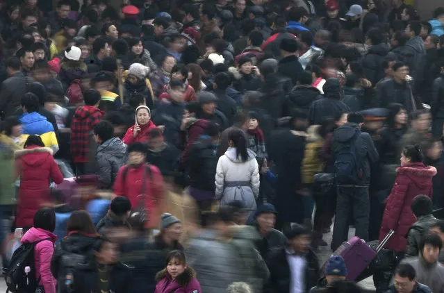 In this January 8, 2012 file photo, people rush to catch their train at Beijing station in Beijing, China as millions of Chinese are expected to cramp onto China's train network in the coming weeks to return home for the Chinese lunar new year. Beijing's city government said Sunday, July 12, 2015 that it is going to move part of its administrative functions out of the city center as part of a plan to better integrate the Chinese capital with its surrounding areas. (Photo by Andy Wong/AP Photo)