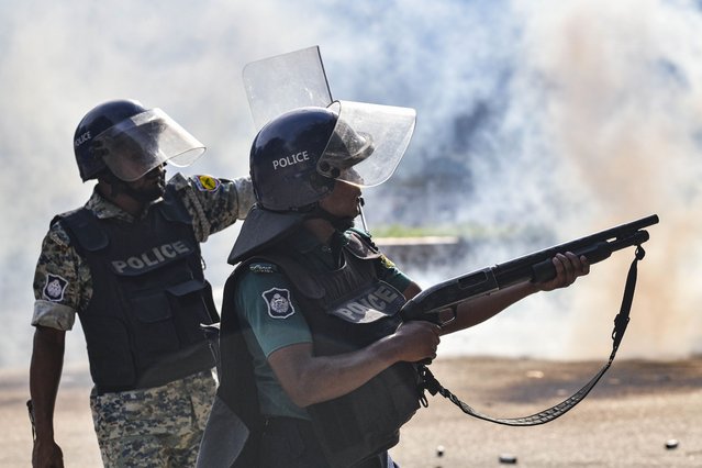 Bangladesh police personnel are firing tear shells as students are protesting against quotas in government jobs alongside symbolic coffins of victims who died in a clash with the police, during their absentee funeral prayer ceremony at Dhaka University in the capital, Dhaka, Bangladesh, on July 17, 2024. Bangladeshi students are mourning classmates killed in protests over civil service hiring rules, a day after the government ordered the indefinite closure of schools nationwide to restore order. (Photo by Zabed Hasnain Chowdhury/NurPhoto via Getty Images)