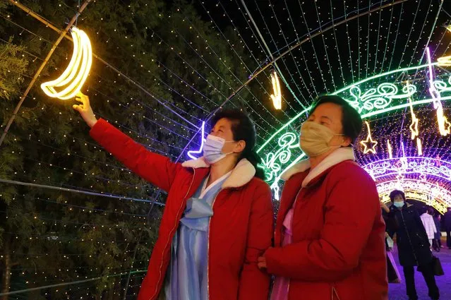 Citizens visit a light festival in celebration of 110th birth anniversary of their late leader Kim Il Sung at Kim Il Sung Square in Pyongyang, North Korea Thursday, April 14, 2022. (Photo by Jon Chol Jin/AP Photo)