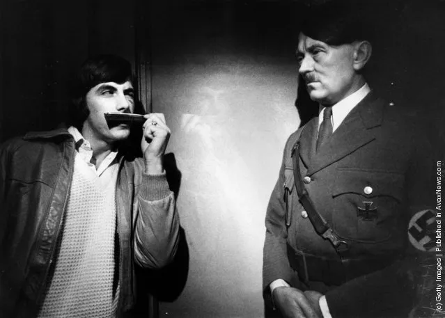 1980: A visitor to Madame Tussaud's tries the effect of a pocket comb to mimic Adolf Hitler's moustache