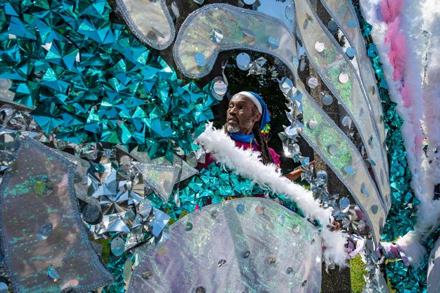 A person builds a “mas” before the parade start during the 51st annual Caribbean American Carnival Association of Boston's parade in Boston, Massachusetts on August 24, 2024. (Photo by Joseph Prezioso/AFP Photo)