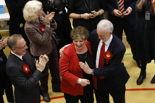 Britain's Labour party leader Jeremy Corbyn, right, tries to high-five with Labour's Emily Thornberry after arriving for the declaration at his constituency in London, Friday, June 9, 2017. Britain voted Thursday in an election that started out as an attempt by Prime Minister Theresa May to increase her party's majority in Parliament ahead of Brexit negotiations but was upended by terror attacks in Manchester and London during the campaign's closing days. (Photo by Frank Augstein/AP Photo)