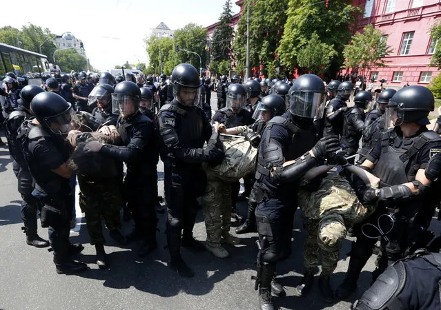 Police arrest anti-gay protesters during the annual Gay Pride parade in Kiev, Ukraine, Sunday, June 18, 2017. (Photo by Sergei Chuzavkov/AP Photo)