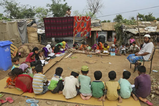 Rohingya refugee children attend a Madrassa, or Islamic religious school in a temporary shelter on the outskirts of Jammu, India, Tuesday, June 20, 2017. Facing persecution in Myanmar, thousands of members of Myanmar’s minority Rohingya community have crossed over to India over the past years. Tuesday marks World Refugee Day. (Photo by Channi Anand/AP Photo)