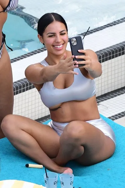 Kanye West's girlfriend, model Chaney Jones wears a silver latex bikini as she lets loose with friends during a pool party in Florida on May 14, 2022. The happy looking group was ready to party as they were seen indulging in both mixed drinks as well as straight tequila shots before some twerking ensued. (Photo by The Mega Agency)