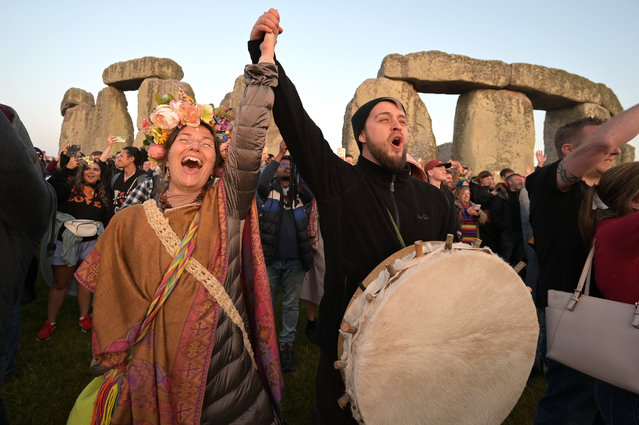 Revellers including Hippies and Druids return to Stonehenge to celebrate the summer Solstice on June 21, 2023. Thousands descended on the ancient stones to witness the sunrise on the longest day of the year. The sun rose at 4:49am and the official Solstice officially begins at 3;57pm GMT. English Heritage allow controlled access to the ancient stone circle to allow the celebration that marks the official start of summer. (Photo by Martin Dalton/Rex Features/Shutterstock)